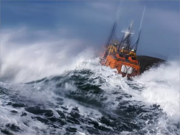 St Davids Tyne class lifeboat Garside 47-026 in rough seas. Three crew can be seen at the upper steering position. Lifeboat is partially obscured by a large wave and lots of white water