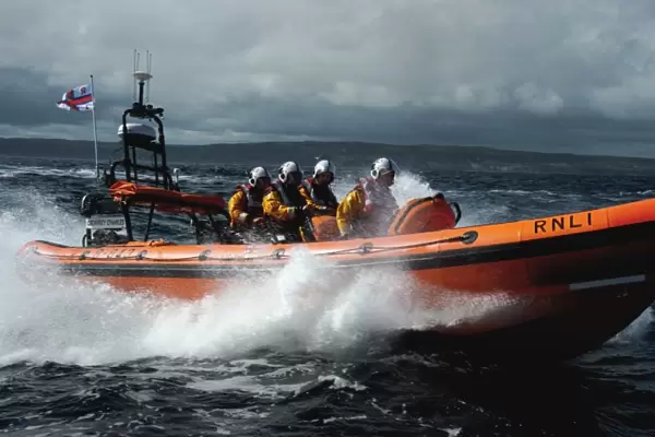 Red Bay Altantic 85 inshore lifeboat Geoffrey Charles B-843. Lifeboat moving from left to right at speed, four crew on board