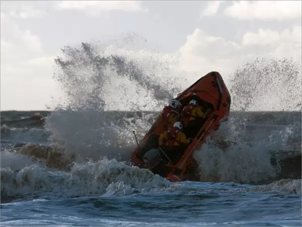 Blackpool D-class inshore lifeboat D-729 launching through a breaking wave