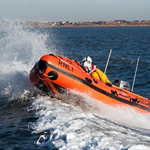 Lytham St Annes D-class inshore lifeboat Sally D-657. Lifeboat moving from right to left, two crew on board