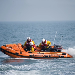 Swanage D-class inshore lifeboat Jack Cleare D-613 heading from right to left three crew on board