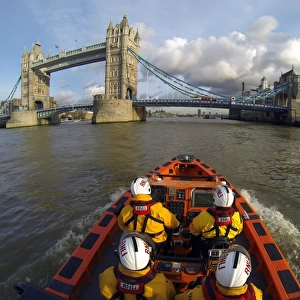Tower E-class lifeboat Hurley Burly E-07 heading along the Thames towards Tower Bridge