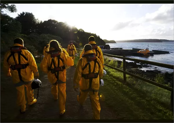Group shot of the Tenby crew members walking along towards the Tamar class lifeboat Haydn Miller 16-02 in the distance