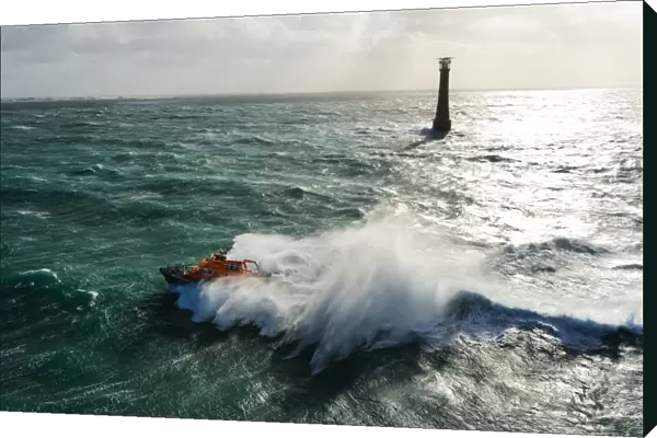 St Marys Severn class lifeboat 17-11 in rough seas off the lighthouse at Bishops Rock, the westnermost point of the Isles of Scilly