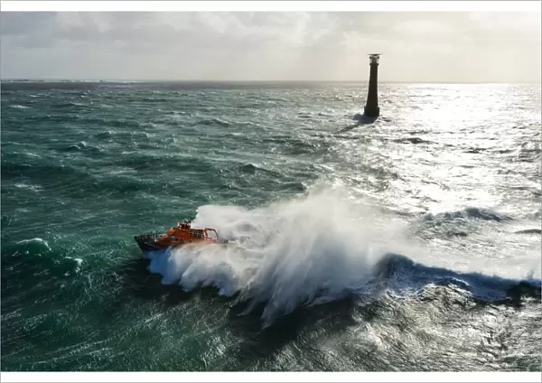 St Marys Severn class lifeboat 17-11 in rough seas off the lighthouse at Bishops Rock, the westnermost point of the Isles of Scilly
