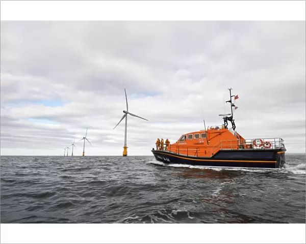 Barrow Tamar class lifeboat Grace Dixon 16-08 at sea, wind farm in teh distance. Shot for Dong Energy partnership press release