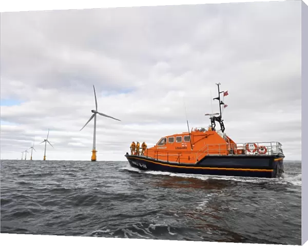 Barrow Tamar class lifeboat Grace Dixon 16-08 at sea, wind farm in teh distance. Shot for Dong Energy partnership press release