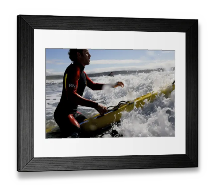 Framed Print : An RNLI lifeguard on a paddleboard at Woolacombe Framed Print : An RNLI lifeguard on a paddleboard at Woolacombe