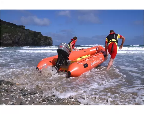 Two RNLI lifeguards launching an Arancia inshore rescue boat