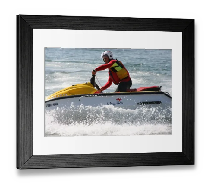 Framed Print : An RNLI lifeguard on a rescue water craft Framed Print : An RNLI lifeguard on a rescue water craft