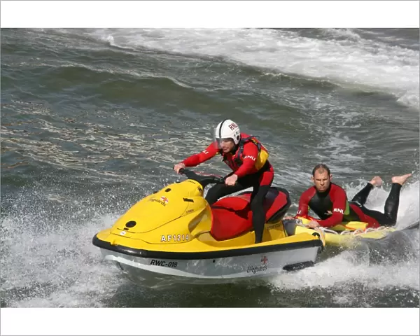 Two beach lifeguards on a rescue water craft