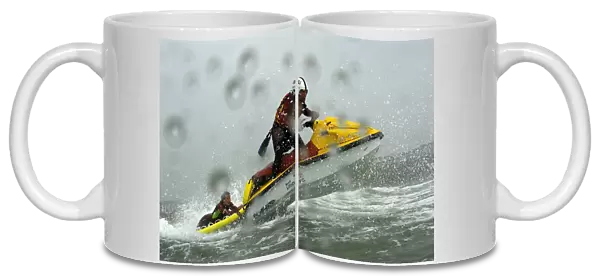 Two beach lifeguards on a rescue water craft