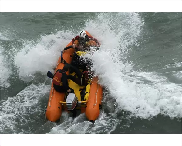 An arancia inshore rescue boat in heavy surf at Perranporth