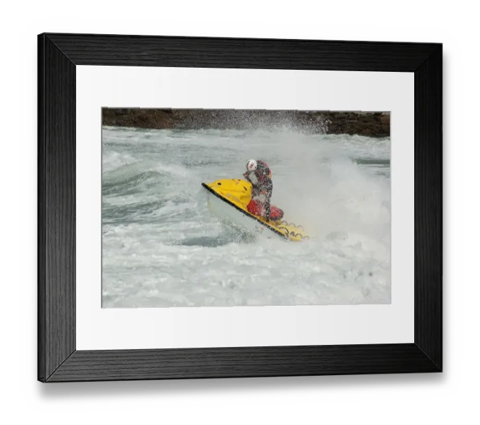 Framed Print : RNLI lifeguard heading out through surf on a rescue watercraft Framed Print : RNLI lifeguard heading out through surf on a rescue watercraft