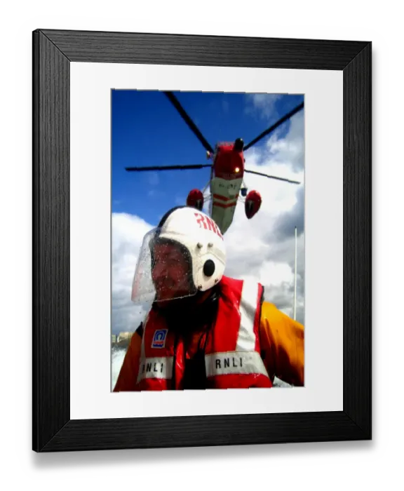 Framed Print : Portrait shot of a coastguard helicopter above an RNLI ILB crew Framed Print : Portrait shot of a coastguard helicopter above an RNLI ILB crew