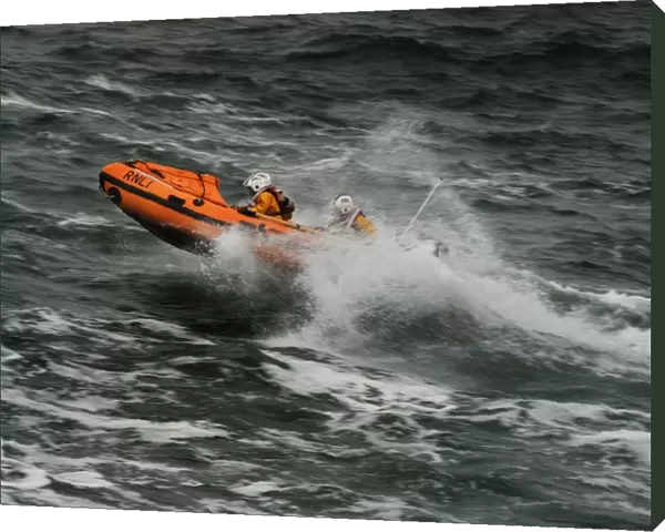 Ballyglass D-class inshore lifeboat The Western D-687. Lifeboat moving from right to left, three crew on board, bow out of the water