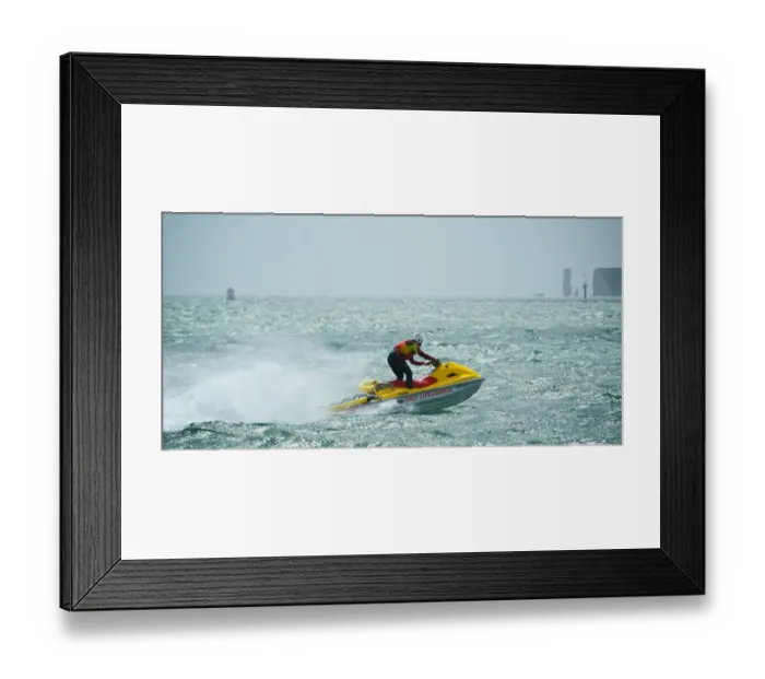 Framed Print : RNLI lifeguard on a rescue watercraft off Sandbanks beach, Poole. Moving from left to right at speed, Old Harry Rocks in the distance Framed Print : RNLI lifeguard on a rescue watercraft off Sandbanks beach, Poole. Moving from left to right at speed, Old Harry Rocks in the distance