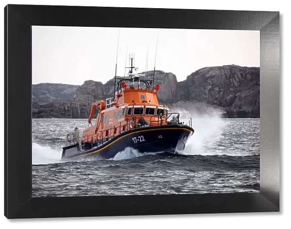 Arranmore severn class lifeboat Mrytle Maud 17-22 moving from left to right at speed, cliffs in the distance