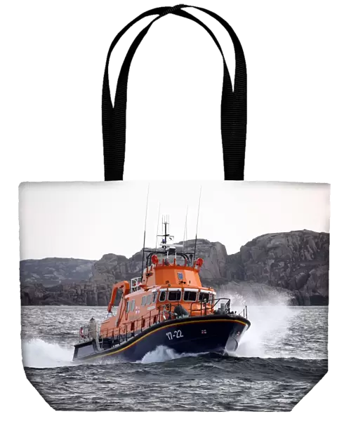 Arranmore severn class lifeboat Mrytle Maud 17-22 moving from left to right at speed, cliffs in the distance