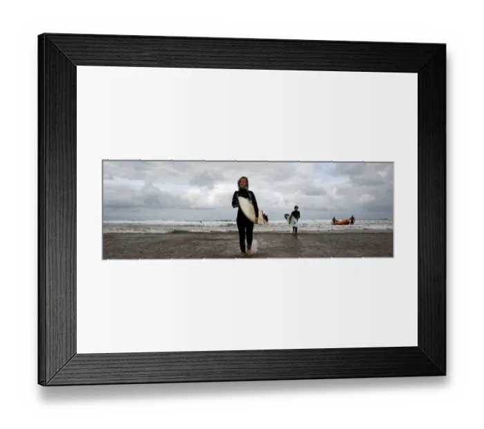 Framed Print : Two surfers walking in from the sea towards the camera, two lifeguards and an arancia in the background. Used as the RNLI You Tube banner Framed Print : Two surfers walking in from the sea towards the camera, two lifeguards and an arancia in the background. Used as the RNLI You Tube banner