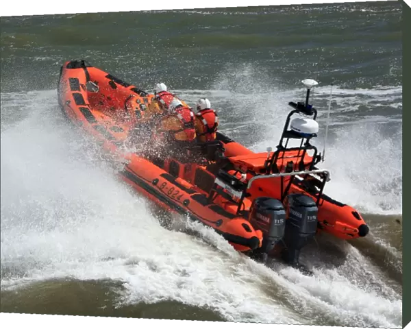 Minehead Atlantic 85 inshore lifeboat Richard and Elizabeth Deaves B-824. Lifeboat heading from away from the camera, four crew on board, lots of white spray
