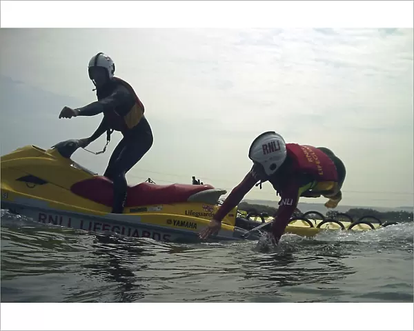 Lifeguard jumping from a rescue watercraft