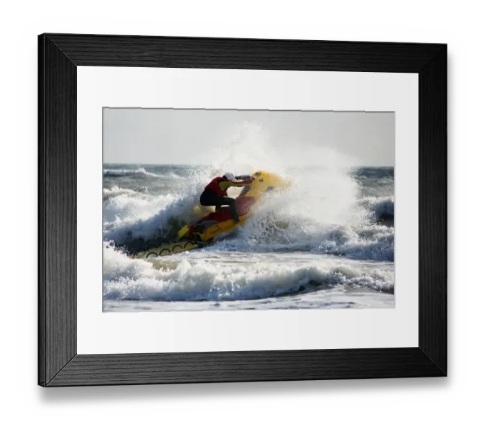 Framed Print : Lifeguards on Boscombe beach, Dorset. Lifeguards are now providing year round cover at Boscombe due to the development of the surf reef. Lifeguard on a rescue watercraft moving from left to right through a breaking wave Framed Print : Lifeguards on Boscombe beach, Dorset. Lifeguards are now providing year round cover at Boscombe due to the development of the surf reef. Lifeguard on a rescue watercraft moving from left to right through a breaking wave