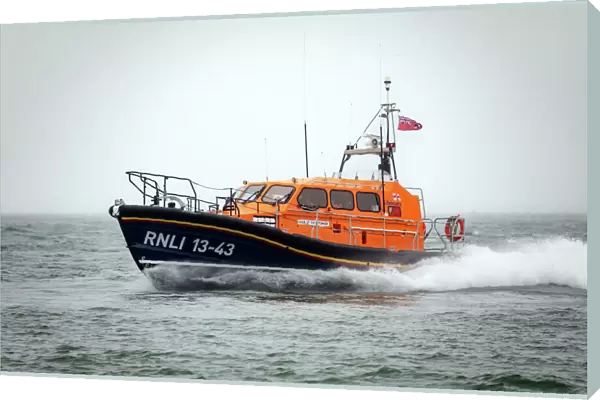 Clifden Shannon class lifeboat St Christopher 13-43 at sea during trials in Poole Bay. Shot from Shell Bay beach, Studland