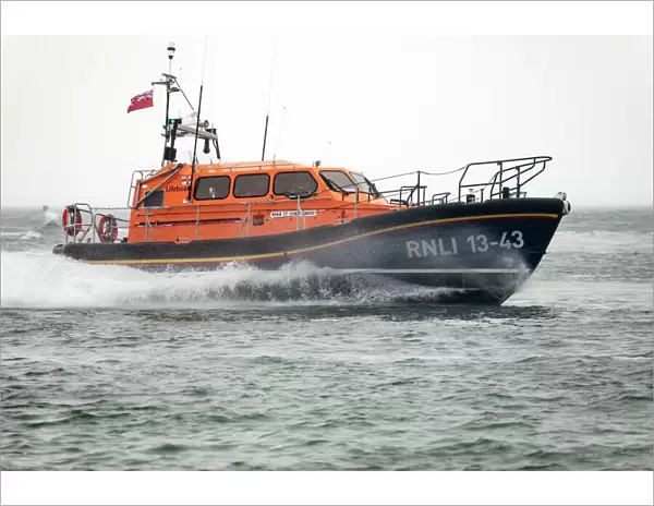 Clifden Shannon class lifeboat St Christopher 13-43 at sea during trials in Poole Bay. Shot from Shell Bay beach, Studland