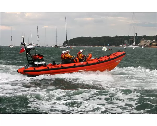 Cowes Atlantic 85 inshore lifeboat Tabbycat B-810 moving from left to right at speed during a demonstration at Cowes Week