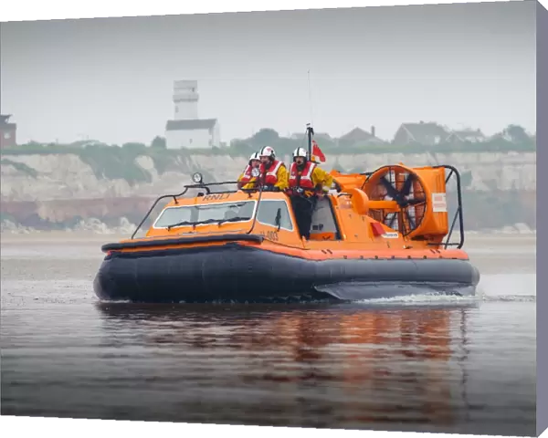 Hunstanton hovercraft The Hunstanton Flyer H-003 heading from right to left over mudflats, four crew on board