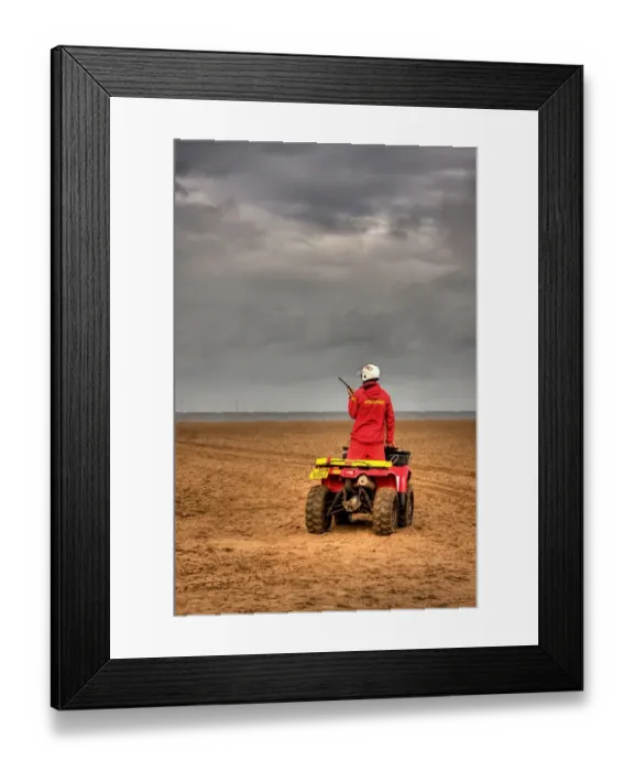 Framed Print : RNLI lifeguard on a quad bike patrol vehicle at Skegness beach Framed Print : RNLI lifeguard on a quad bike patrol vehicle at Skegness beach