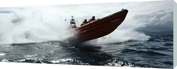 Red Bay Altantic 85 inshore lifeboat Geoffrey Charles B-843. Lifeboat moving from left to right at speed, four crew on board, lots of white spray, bow high out of the water