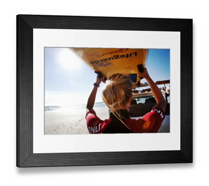 Framed Print : Female lifeguard lifting rescue boards down from a patrol vehicle Framed Print : Female lifeguard lifting rescue boards down from a patrol vehicle