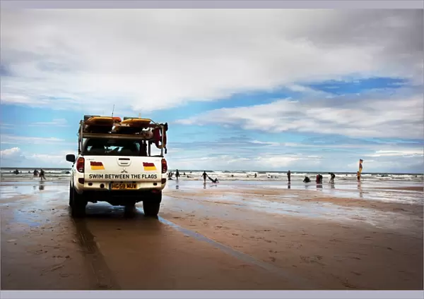 Lifeguards monitoring the beach from a patrol vehicle