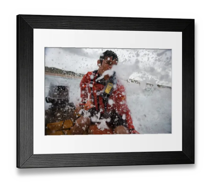 Framed Print : Lifeguard at the helm of an arancia inshore rescue boat at Constantine Bay, Cornwall Framed Print : Lifeguard at the helm of an arancia inshore rescue boat at Constantine Bay, Cornwall