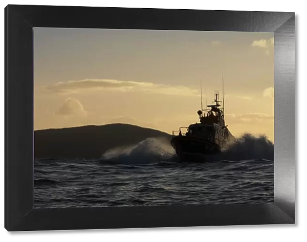 Achill Island trent class lifeboat Sam and Ada Moody 14-28. Lifeboat is heading towards the camera, silhouetted against a dramatic sky