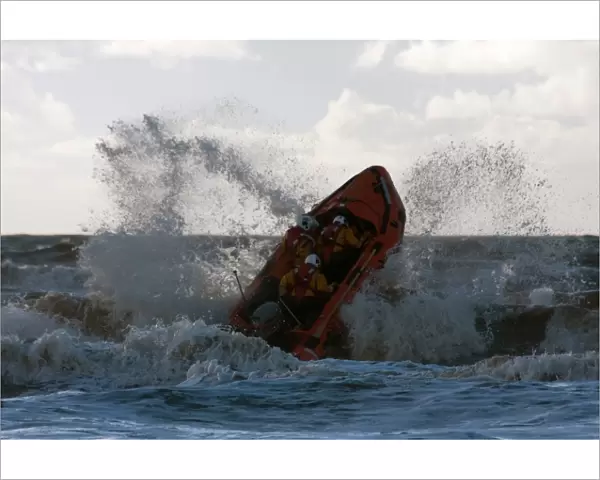 Blackpool D-class inshore lifeboat D-729 launching through a breaking wave
