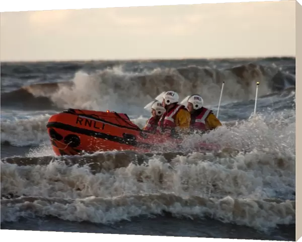 Blackpool D-class inshore lifeboat D-729 in surf, three crew on board
