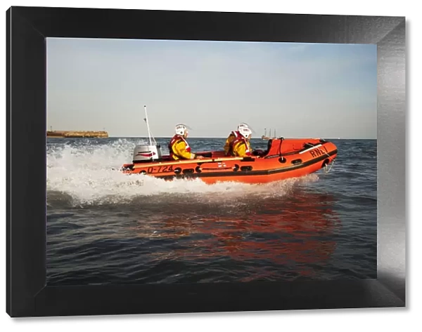 Exercise between Scarborough D-class inshore lifeboat and lifeguards. D-class John Wesley Hillard III D-724 lifeboat moving from left to right