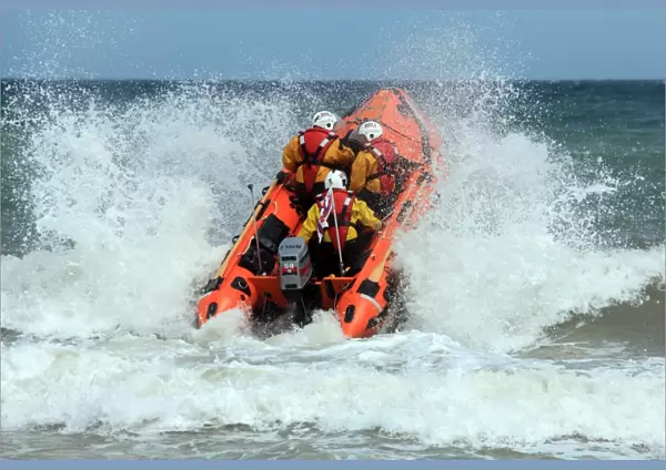 Cromer D-class inhsore lifeboat George and Muriel D-734 heading through a breaking wave following her naming ceremony
