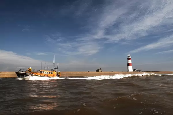 Aldeburgh mersey class lifeboat Freddie Cooper 12-34 moving from right to left, lighthouse in the background