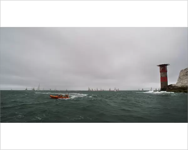 Lymington Atlantic 75 inshore lifeboat Victor Danny Lovelock B-784 during the Round the Island Race 2011. Racing yachts and the Needles lighthouse in the distance