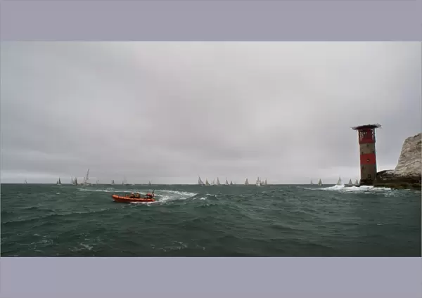 Lymington Atlantic 75 inshore lifeboat Victor Danny Lovelock B-784 during the Round the Island Race 2011. Racing yachts and the Needles lighthouse in the distance