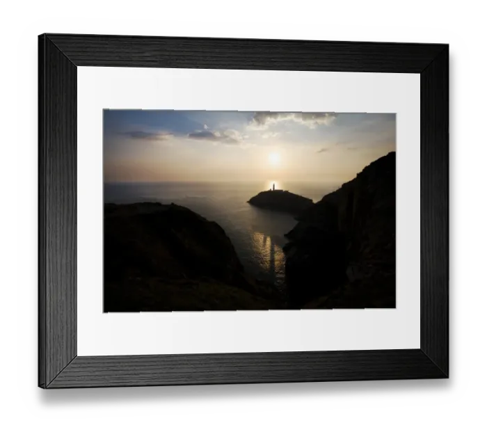 Framed Print : Landscape shot of sun setting behind lighthouse near Beaumaris Framed Print : Landscape shot of sun setting behind lighthouse near Beaumaris