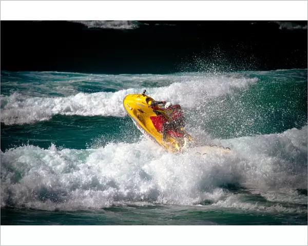 Lifeguard on a rescue watercraft (RWC) in the surf at Perranporth beach, Cornwall