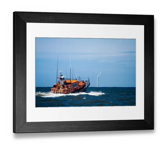 Framed Print : Rhyl Mersey class lifeboat Lil Cunningham 12-24 heading out to sea, windfarms in the distance Framed Print : Rhyl Mersey class lifeboat Lil Cunningham 12-24 heading out to sea, windfarms in the distance