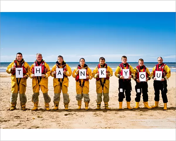 Crew members at Rhyl holding up letters spelling out the words Thank You. Left to right: Paul Frost MBE (Deputy 2nd coxswain  /  LPO), Derek Denton (Tractor drive  /  ALB crew), Bob Baines (Tractor driver  /  ALB crew), Tina Elliot (ALB crew)