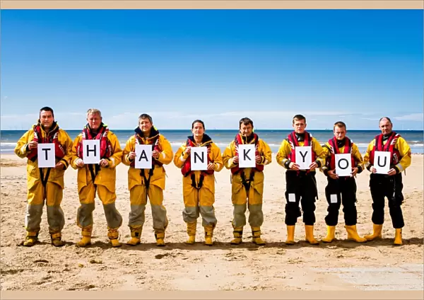 Crew members at Rhyl holding up letters spelling out the words Thank You. Left to right: Paul Frost MBE (Deputy 2nd coxswain  /  LPO), Derek Denton (Tractor drive  /  ALB crew), Bob Baines (Tractor driver  /  ALB crew), Tina Elliot (ALB crew)