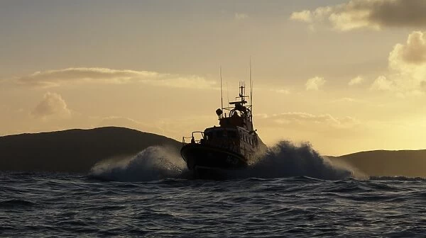 Achill Island trent class lifeboat Sam and Ada Moody 14-28. Lifeboat is heading towards the camera, silhouetted against a dramatic sky